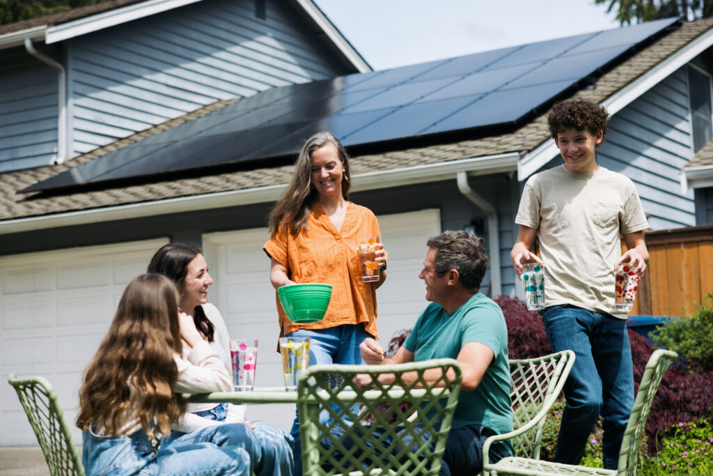 Family enjoying time outside in front of their home